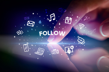 Finger touching tablet with drawn social media icons and FOLLOW inscription, social networking concept