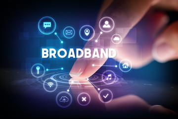 Finger touching tablet with web technology icons and BROADBAND inscription, web technology concept