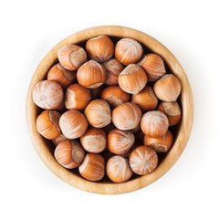Hazelnuts in wooden bowl isolated on white background with clipping path