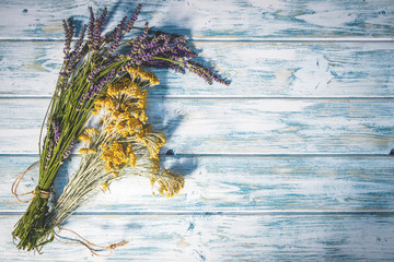 Bunch of herbs on wooden table. Lavender and helychrisum (asteraceae)