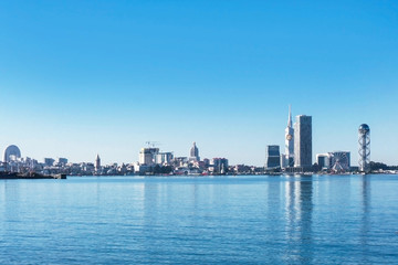 Fototapeta na wymiar Blue sky color Batumi cityscape. Empty copy space Georgian city panoramic view. Sea shore touristic district.