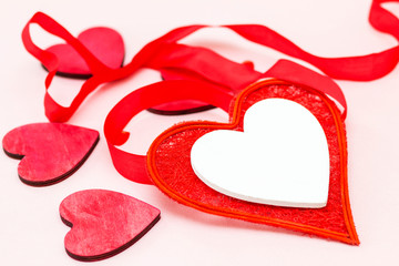 beautiful red heart decorated with ribbon on a light background