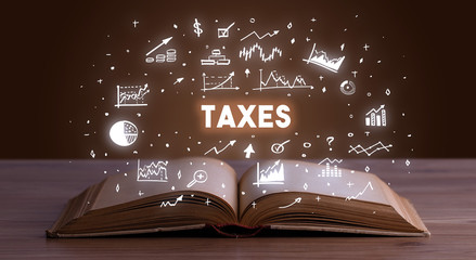 TAXES inscription coming out from an open book, business concept