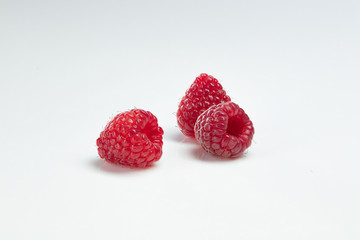 Red raspberries on white background. 