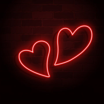 Two different glowing neon hearts on a brick wall for Valentines day card design. Vector illustration.