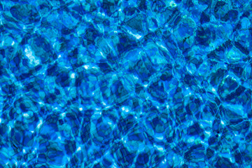 Blue background with lots of light spots. Sun glare in the pool