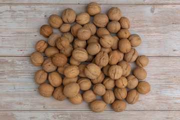 Whole walnuts on rustic old wooden table