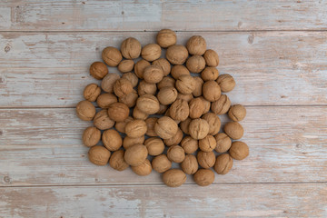 Whole walnuts on rustic old wooden table
