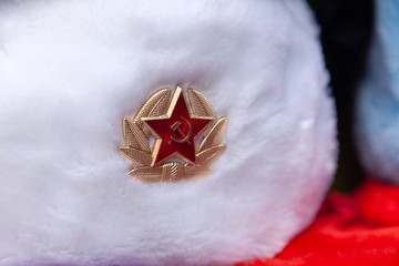 Earflaps fur caps with red stars in souvenir shop in Moscow street. Winter hats, soviet and russian...