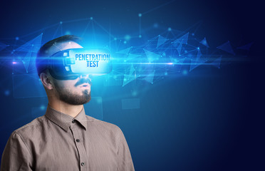 Businessman looking through Virtual Reality glasses with PENETRATION TEST inscription, cyber...