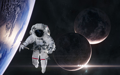 Astronaut in orbit of planet in deep space. Rising star. Science fiction. Elements of this image furnished by NASA
