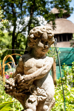 Picture of a garden statue that looks like Cupid 