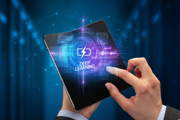 Businessman holding a foldable smartphone with WEB DESIGN inscription, new technology concept DEEP...