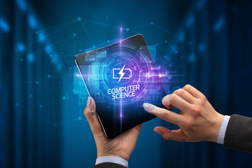 Businessman holding a foldable smartphone with ENERGY inscription, new technology concept COMPUTER SCIENCE
