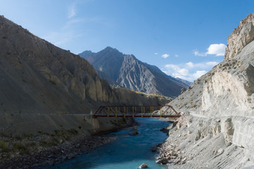 An old iron hanging suspension bridge Overpass Crossing over mountain river valley on a background of hills. Geographical border area remote location, Kaza Himachal Pradesh India South Asia Pac