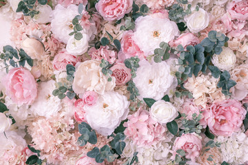 Background panel of artificial flowers peonies, roses and eucalyptus.