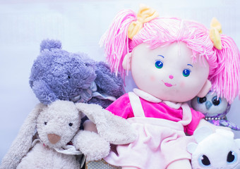 Various soft toys in one place on a single colored background