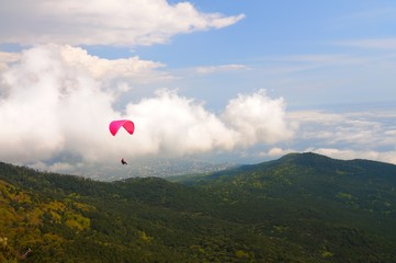 Skydiver flies over the mountains