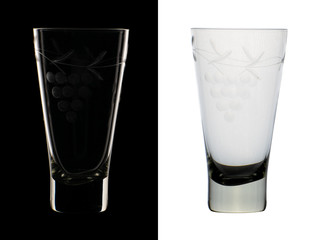 A glass of glass with an engraved pattern presented in two versions isolated on black and white background