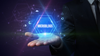 Man hand holding MICROBLOGS inscription, social media concept