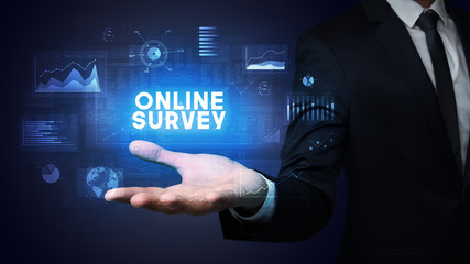 Hand of Businessman holding ONLINE SURVEY inscription, business success concept