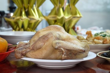 Boiled chicken in a white plate on the table