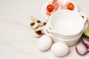Obraz na płótnie Canvas breakfast ingredients: eggs and vegetables, bacon