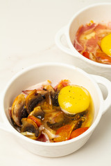 fried eggs with mushrooms and tomatoes