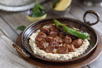 Turkish Sauteed Lamb Meat Served with Smoked Eggplant and Yogurt Puree, Garnished with Grilled Hot Pepper. Ali Nazik Kebab