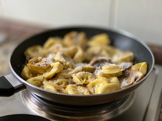 ravioli with mushrooms in a pan