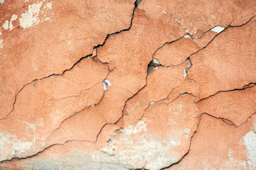 Concrete painted wall with falling cracked paint.