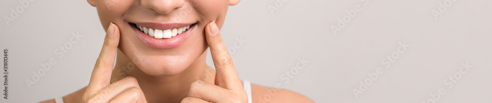 Wall mural closeup view of female wide cheerful smile with white teeth and clean skin and copyspace