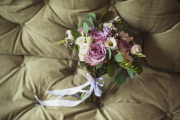bridal bouquet lays on textured stylish fabric background