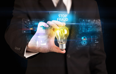 Businessman holding lightbulb with STOP FRAUD inscription, online security idea concept
