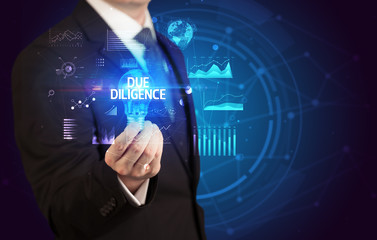 Businessman holding lightbulb with DUE DILIGENCE inscription, Business idea concept