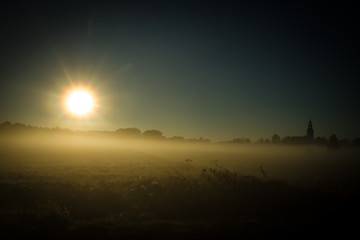 Sun over low fog clouds