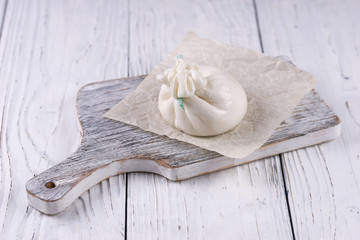 Burrata cheese bag on wooden background