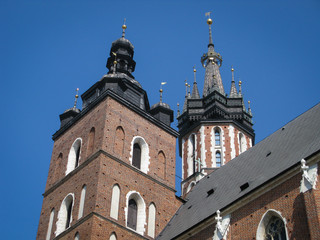 bottom view of the towers of the St. Mary's Basilica on a background of blue sky, Krakow, Poland