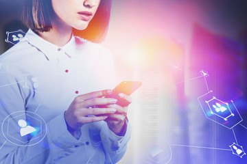Woman with smartphone in city, social network