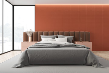 Orange master bedroom with brown bed