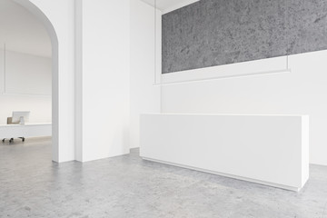 White reception desk in open space office