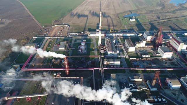 flight over the potash plant, buildings and warehouses are visible, smoke pipes, shooting from above, the camera moves down