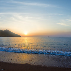 sandy sea beach at the sunrise, early morning sea scene