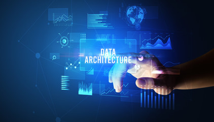 Hand touching DATA ARCHITECTURE inscription, new business technology concept
