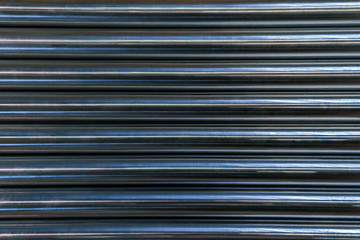 abstract industrial background of shiny cnc turned rods with flat lay horizontal parallel geometric...