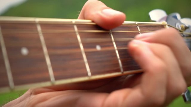 Slow motion of the basic chords that are used for the guitar, close up, blurred, copyspace