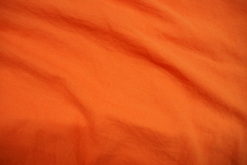 Top view of beautiful warm orange and red tone crumpled fabric for background and decoration