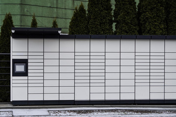 Boxes for parcels and letters on the street, an automatic machine for delivering parcels or ending machine or dispenser. Self-service post terminal machine or locker to deposit