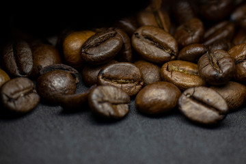 Coffee in beans on dark background. Abstract background texture.Coffee beans texture. Food...