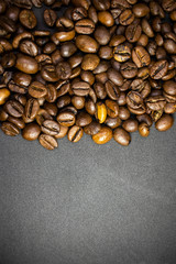 Coffee in beans on dark background. Abstract background texture.Coffee beans texture. Food background of coffee beans